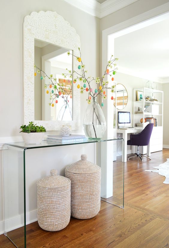 entryway with a ghost console table and woven baskets