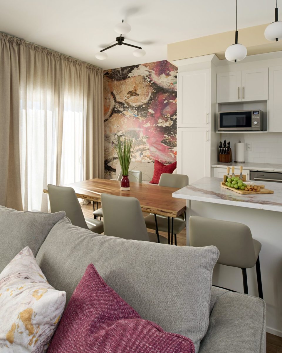 Contemporary open-concept living space with greige palette and vibrant decor